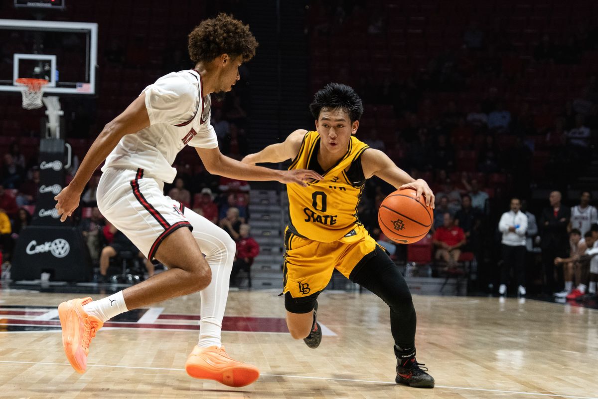 Long Beach State guard Jaden Tengan (0) dribbles past defenders during an NCAA basketball exhibition game against SDSU, Wednesday October 28, 2026 in San Diego, California. Long Beach State guard Jaden Tengan (0) dribbles past defenders during an NCAA basketball exhibition game against SDSU, Wednesday October 28, 2026 in San Diego, California.