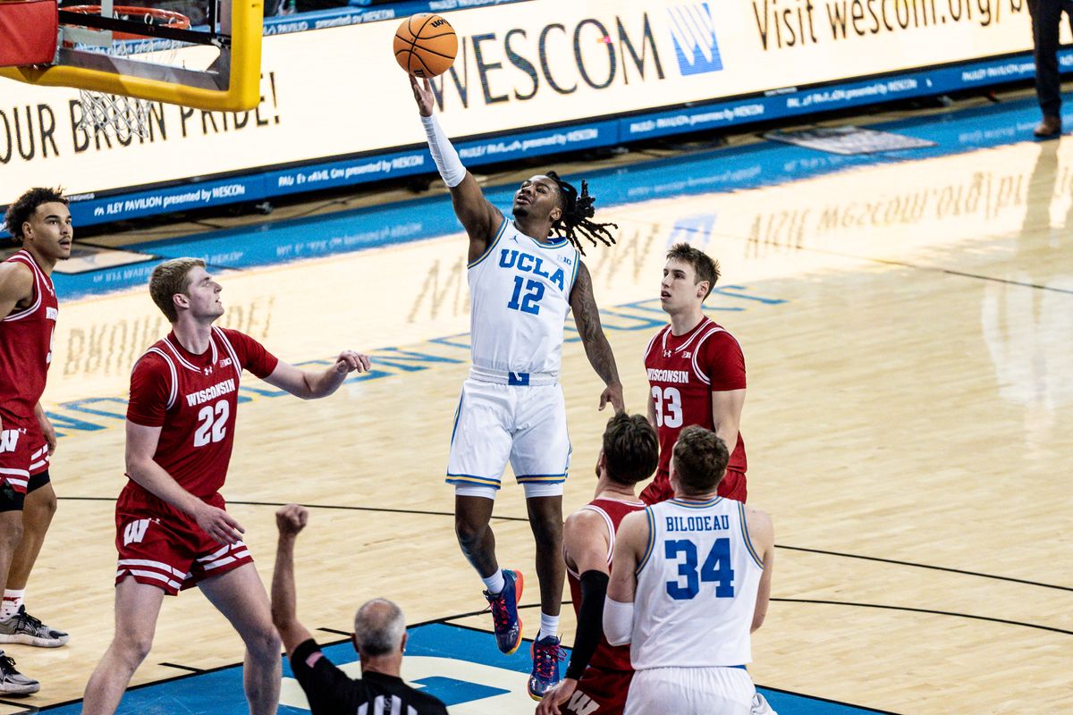 UCLA Bruins G Sebastian Mack (12) attacks the rim for two points in the game against Wisconsin on Tuesday, January 21, 2025, at Pauley Pavilion in Los Angeles, CA.