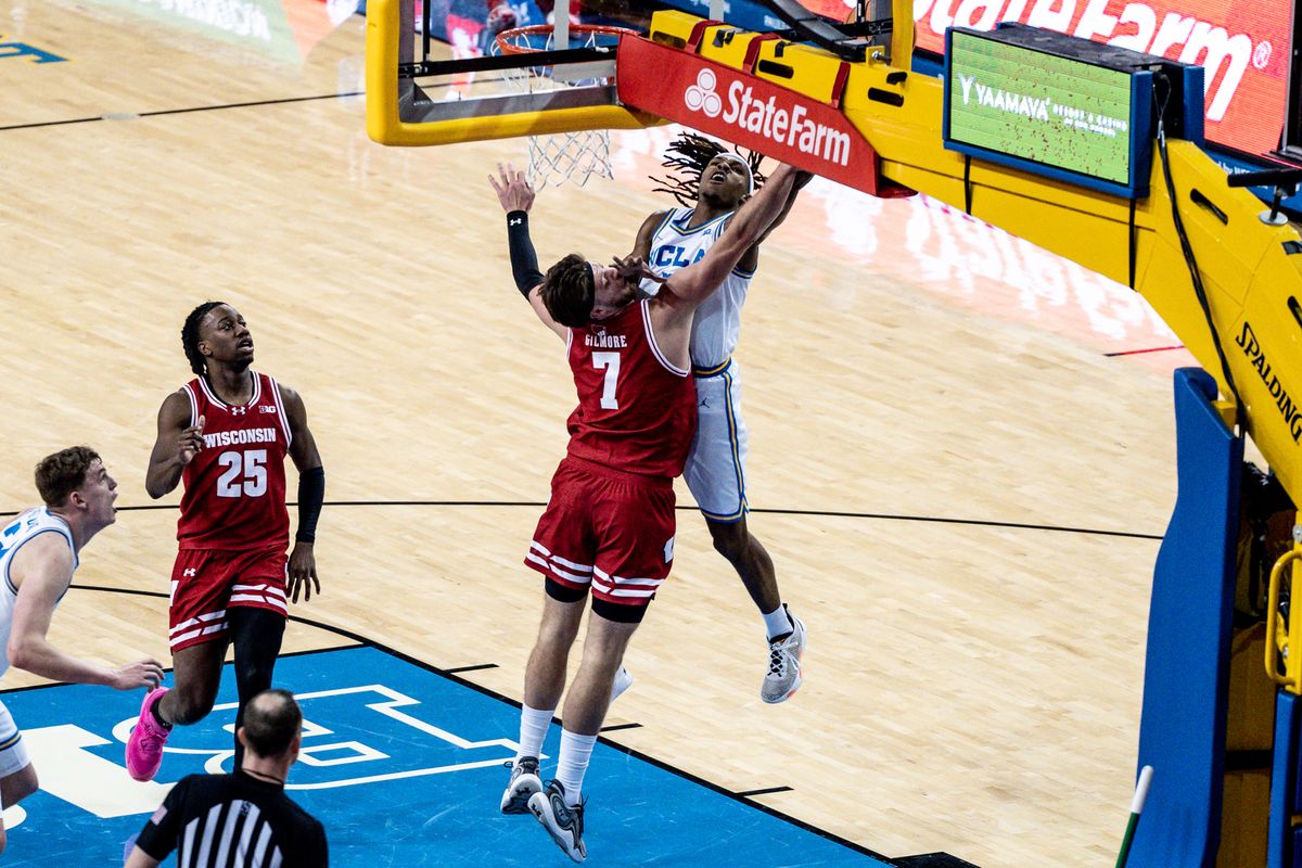 UCLA Bruins G Dylan Andrews (2) attacks the rim for two points and the foul in the game against Wisconsin on Tuesday, January 21, 2025, at Pauley Pavilion in Los Angeles, CA.
