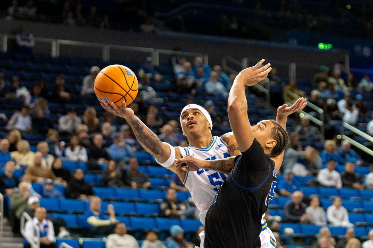 UCLA guard Skyy Clarke (55) gets by the defense for a layup during an NCAA basketball game against Presbyterian, Friday November 21st, 2025 in Los Angeles, California. 