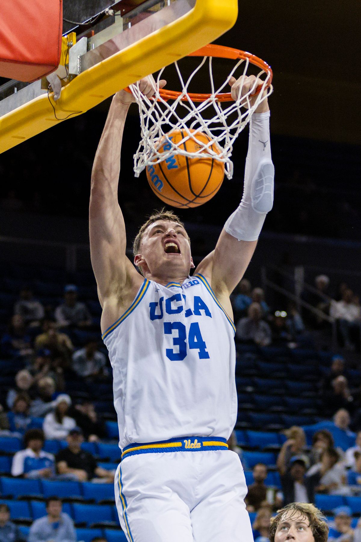 Tyler Bilodeau #34 of the UCLA Bruins dunks the ball during an NCAA basketball game against the Cal Poly Mustangs, Friday December 19, 2025 in Los Angeles, Calif.