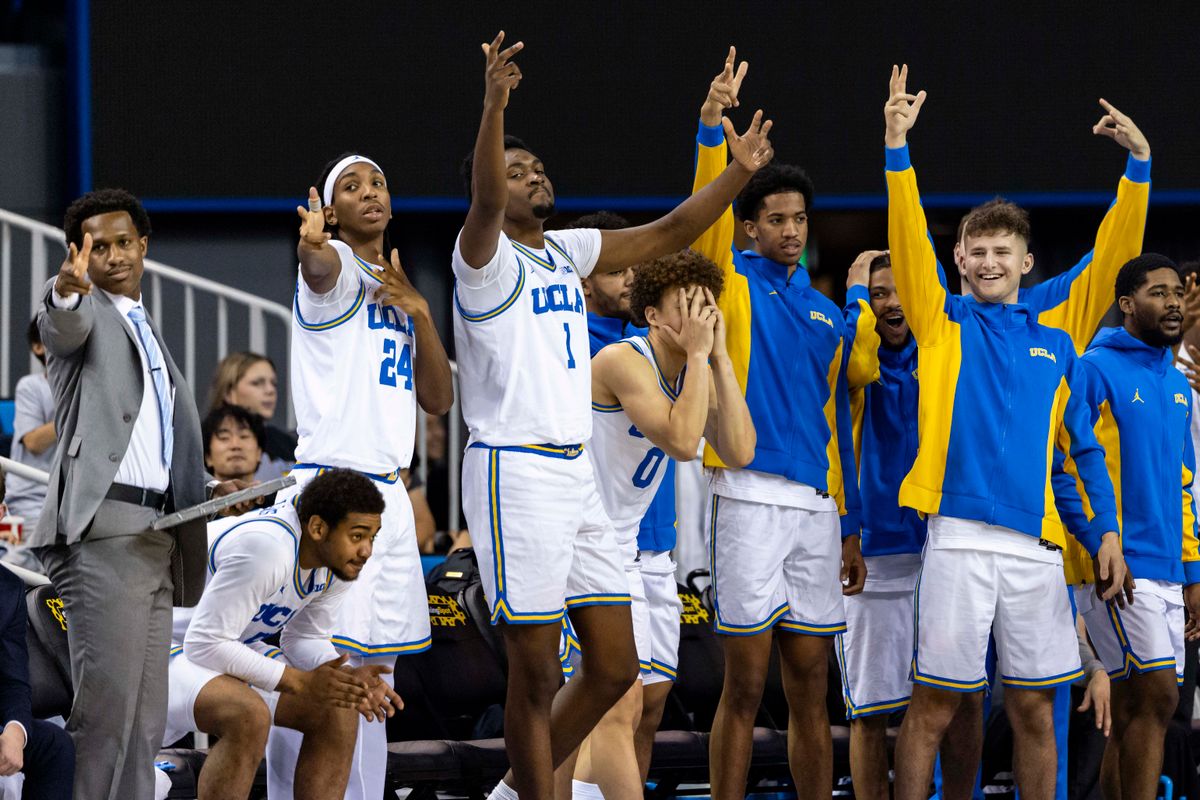 The UCLA Bruins bench celebrates a made three point shot during an NCAA basketball game against the Cal Poly Mustangs, Friday December 19, 2025 in Los Angeles, Calif.