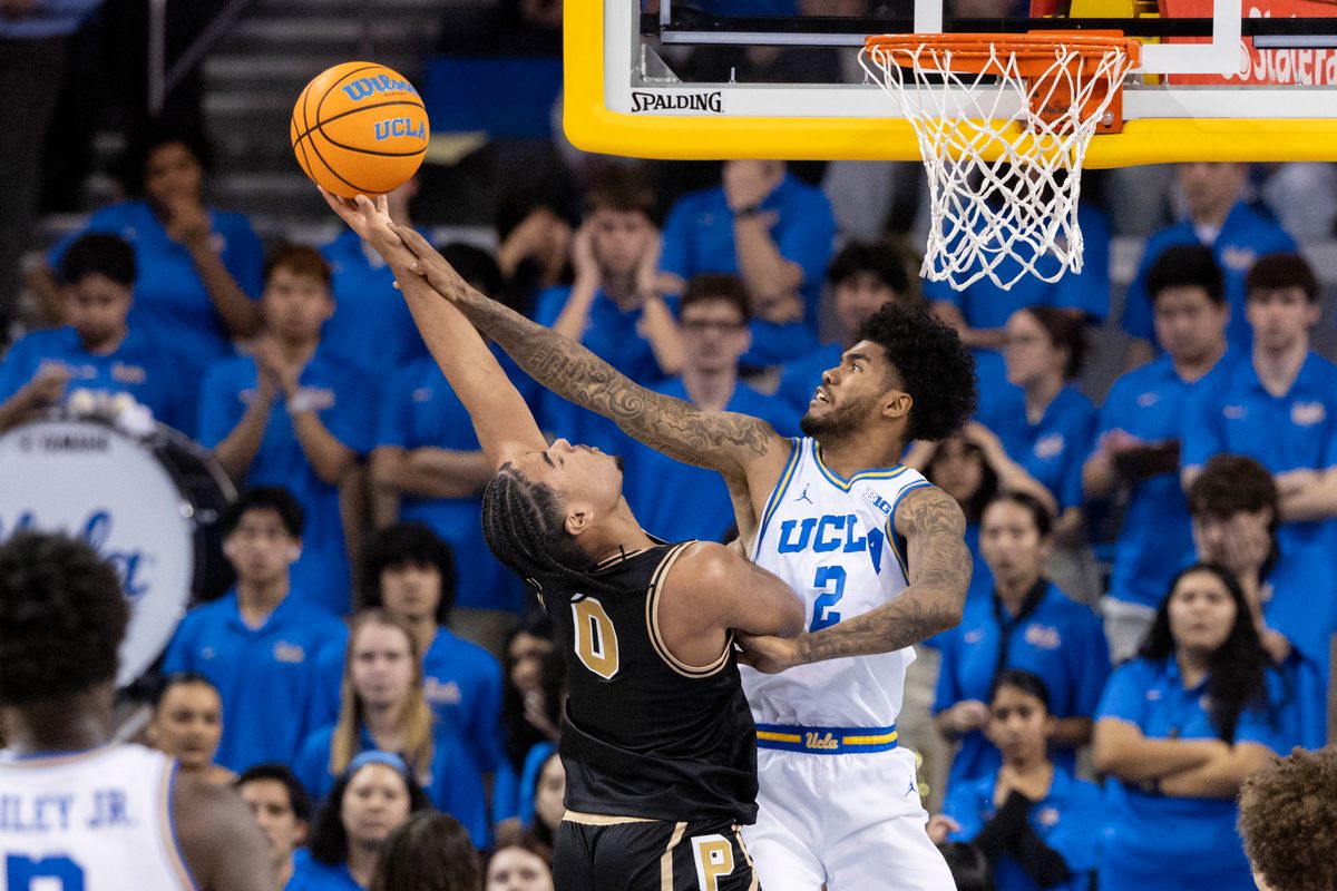C.J. Cox #0 of the Purdue Boilermakers attempts a shot against Donovan Dent #2 of the UCLA Bruins during an NCAA basketball game, Tuesday January 20, 2026 in Los Angeles, Calif.