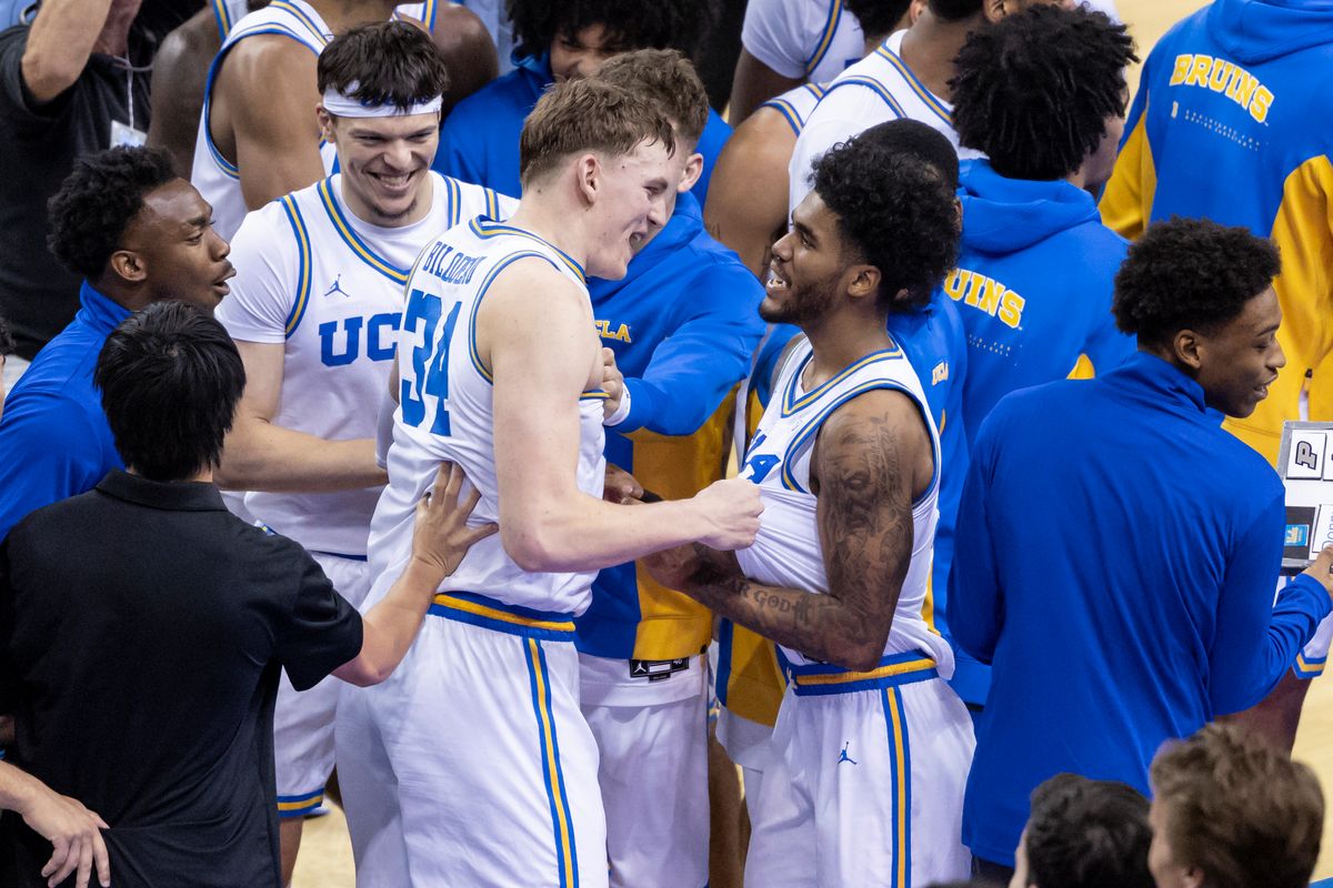 Tyler Bilodeau #34 and Donovan Dent #2 of the UCLA Bruins celebrate the upset victory after an NCAA basketball game against the Purdue Boilermakers, Tuesday January 20, 2026 in Los Angeles, Calif.