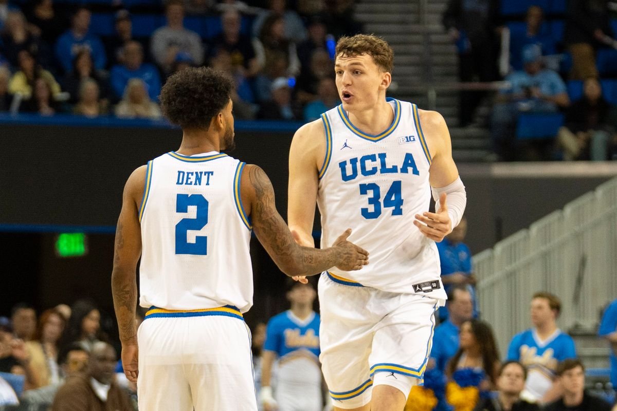 UCLA forward Tyler Bilodeau (34) talks it out with guard Donovan Dent (2) after a turnover during an NCAA basketball game against Washington, Saturday February 7th, 2026 in Los Angeles, California. 