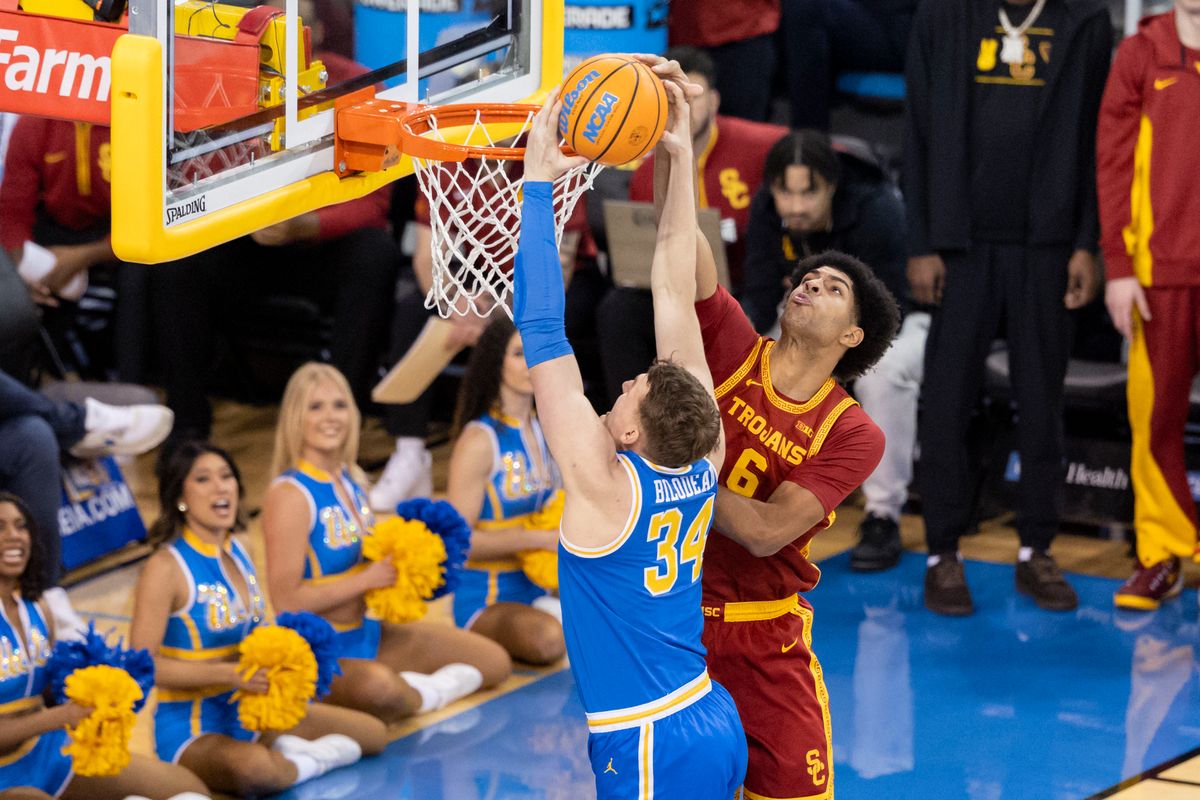 Jacob Cofie #6 of the USC Trojans blocks the dunk by Tyler Bilodeau #34 of the UCLA Bruins during an NCAA basketball game, Tuesday February 24, 2026 in Los Angeles, Calif.