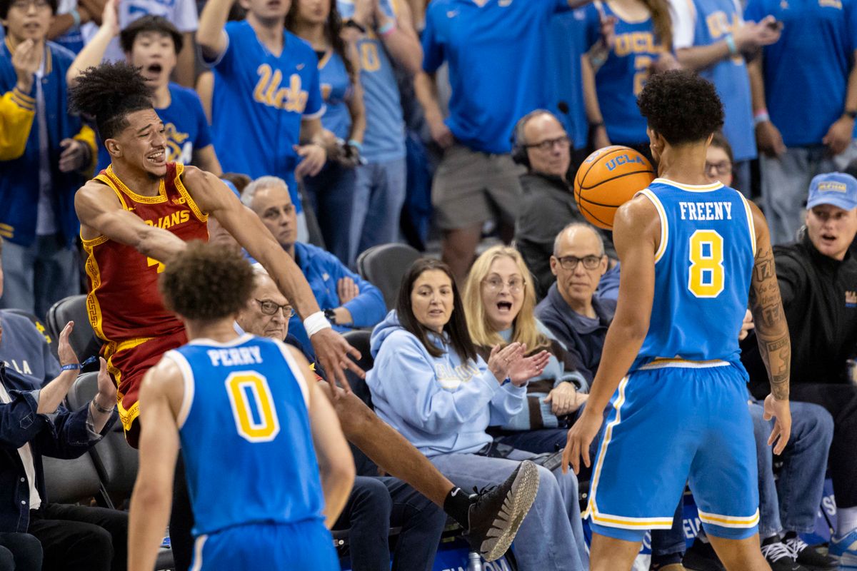 Chad Baker-Mazara #4 of the USC Trojans saves the ball by throwing off the face of Eric Freeny #8 of the UCLA Bruins during an NCAA basketball game, Tuesday February 24, 2026 in Los Angeles, Calif.