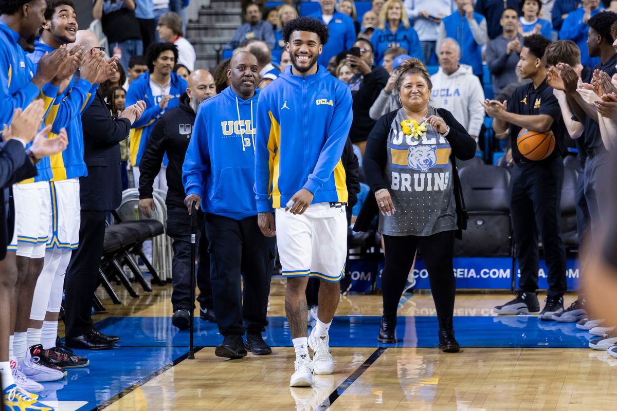 Donovan Dent #2 of the UCLA Bruins walks out with his parents during the senior night ceremony before an NCAA basketball game against the Nebraska Cornhuskers, Tuesday March 3, 2026 in Los Angeles, Calif.