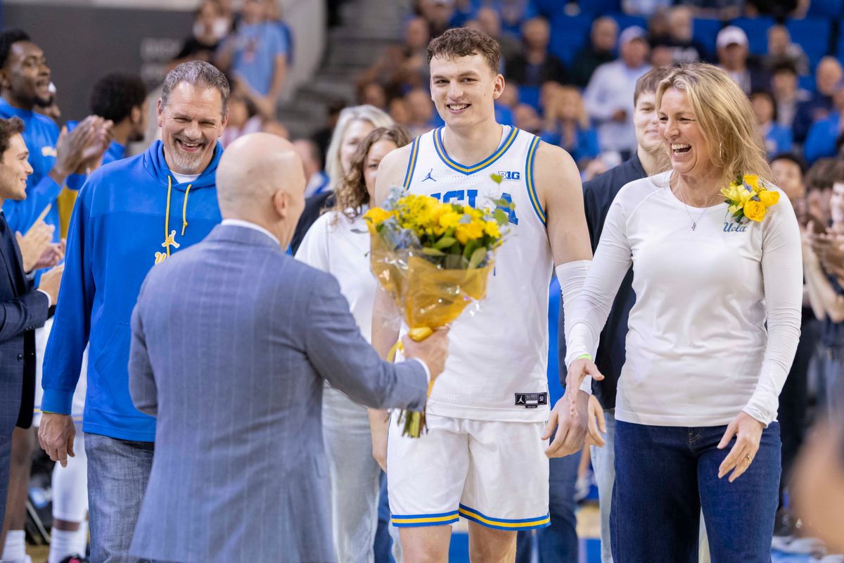 Tyler Bilodeau #34 of the UCLA Bruins and his parents are greeted by head coach Mick Cronin of the UCLA Bruins during the senior night ceremony before an NCAA basketball game against the Nebraska Cornhuskers, Tuesday March 3, 2026 in Los Angeles, Calif.