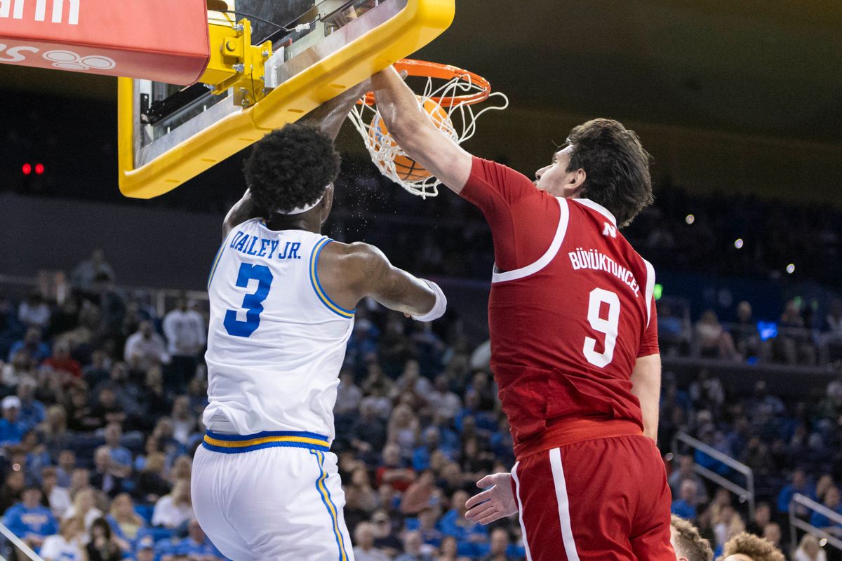 Eric Dailey Jr. #3 of the UCLA Bruins dunks the ball over Berke Büyüktuncel #9 of the Nebraska Cornhuskers during an NCAA basketball game, Tuesday March 3, 2026 in Los Angeles, Calif.