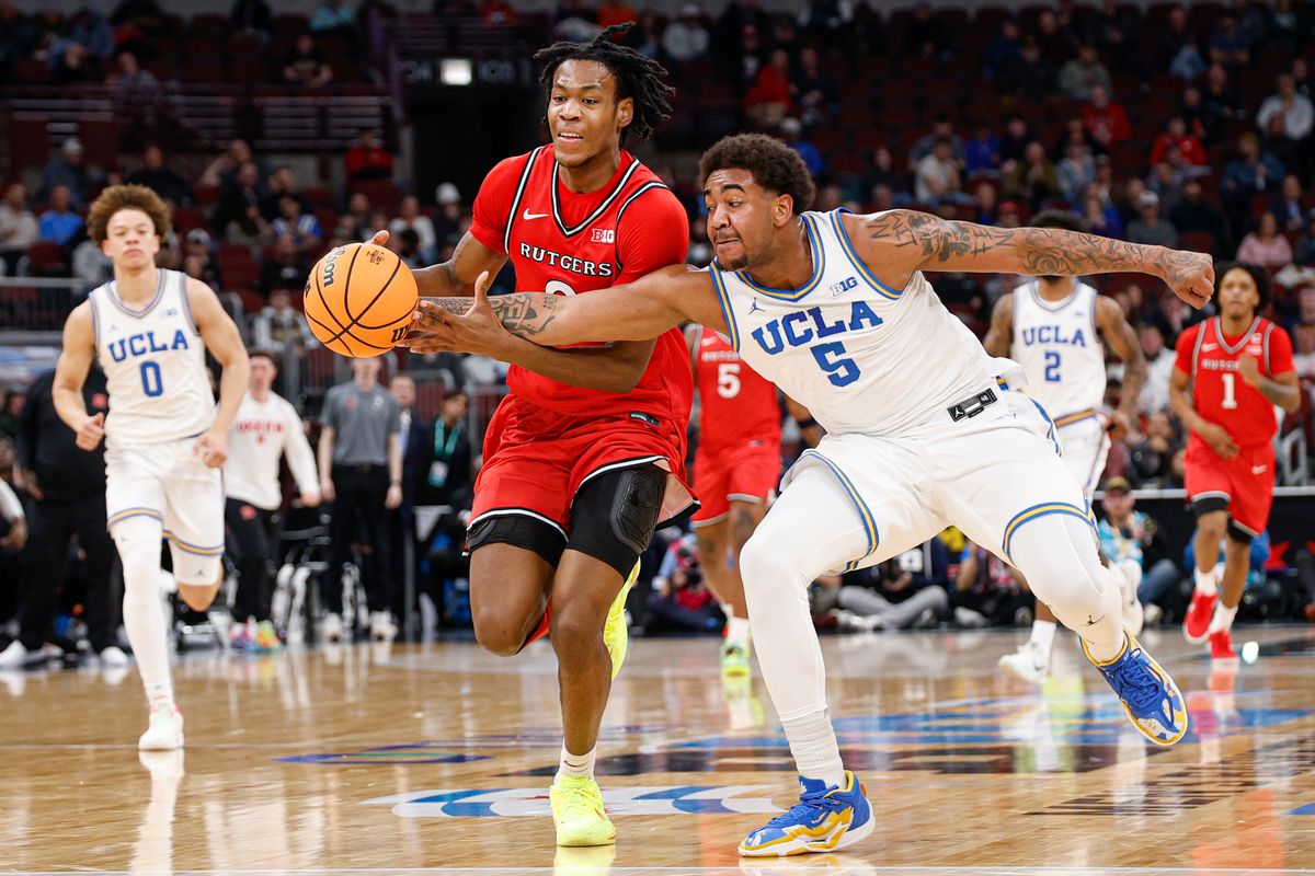 UCLA Bruins guard Brandon Williams (5) defends against Rutgers Scarlet Knights forward Dylan Grant (9) during the first half at United Center.