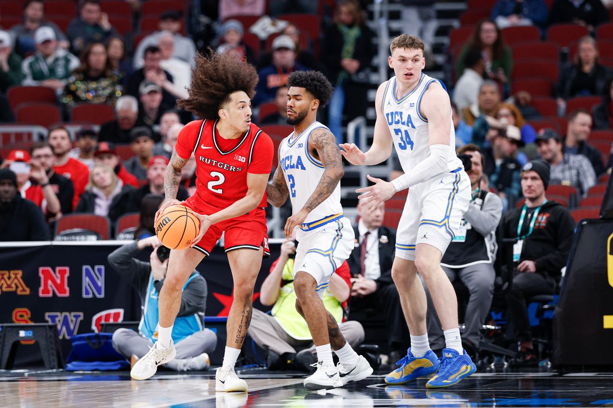 Rutgers Scarlet Knights guard Lino Mark (2) looks to pass the ball against UCLA Bruins guard Donovan Dent (2) during the second half at United Center. 