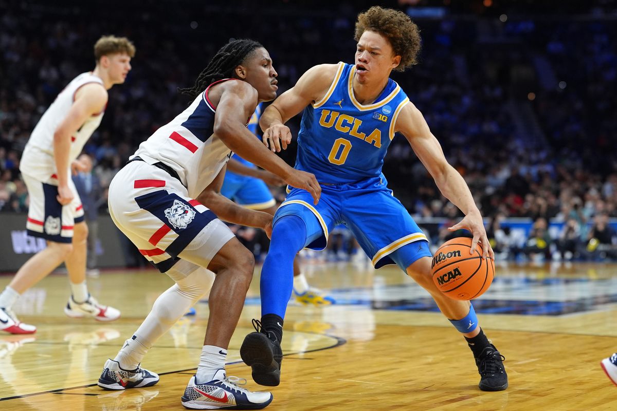 UCLA Bruins guard Trent Perry (0) dribbles the ball against the UConn Huskies in the first half during a second round game of the men's 2026 NCAA Tournament at Xfinity Mobile Arena.