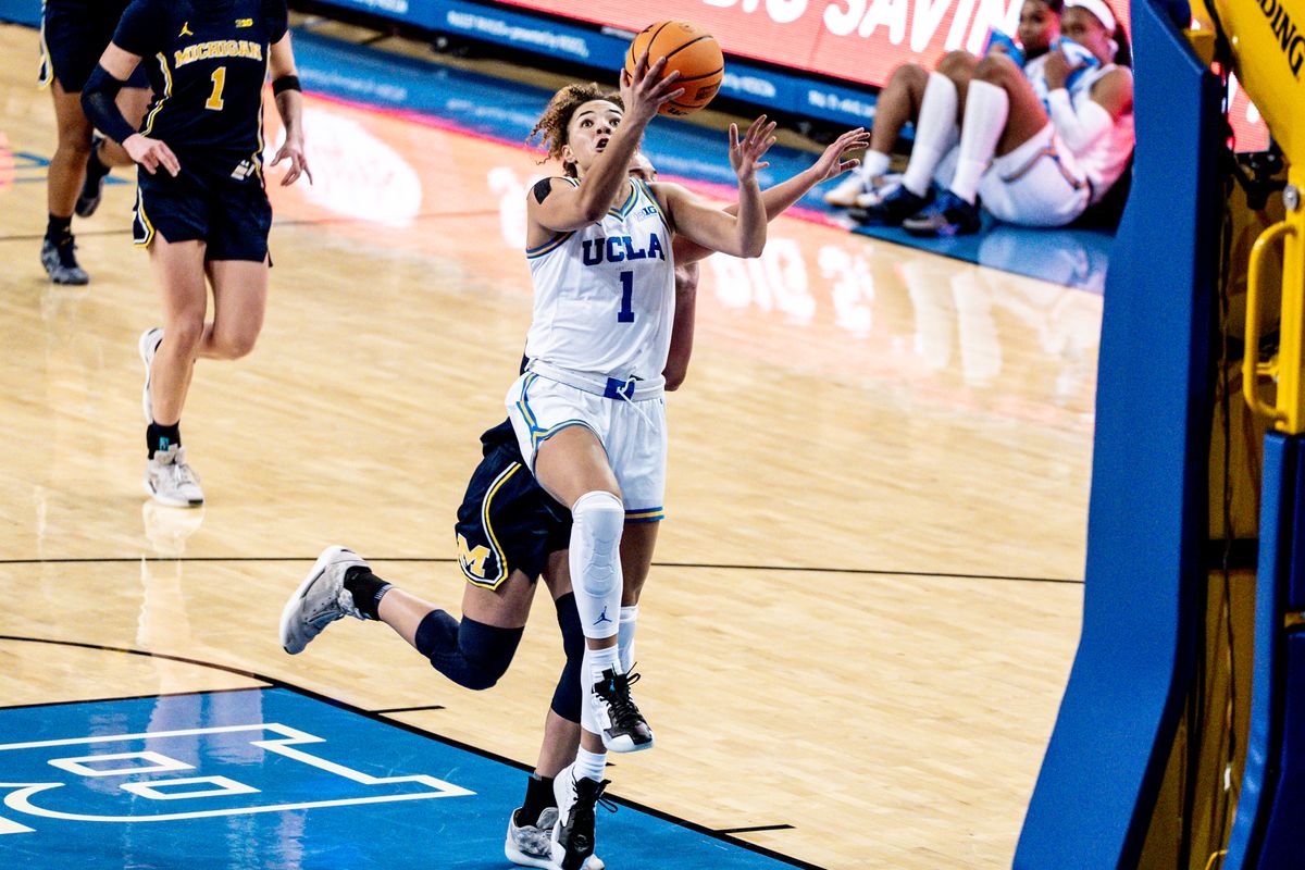 UCLA G KiKi Rice (1) attacks the rim and scores during an NCAA basketball game against the Michigan Wolverans, Wednesday January 1st, 2025 in Los Angeles, California. 