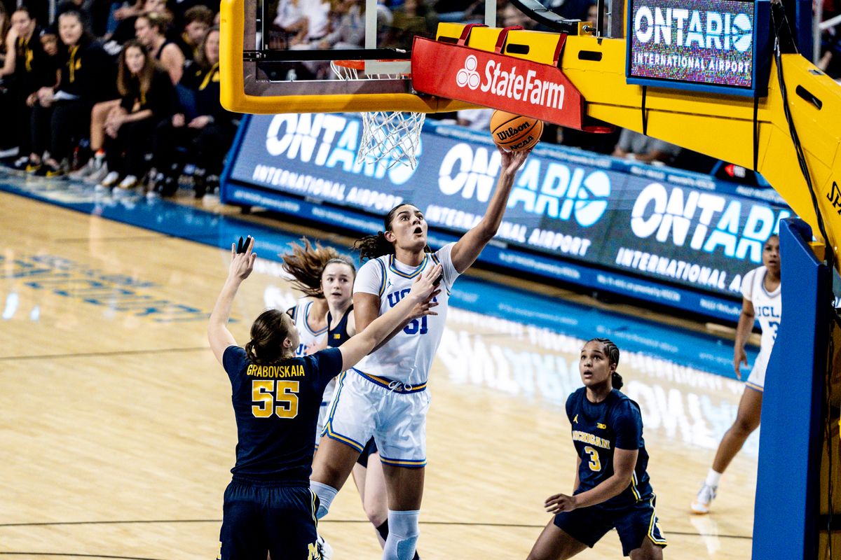 UCLA C Lauren Betts (51) makes a contested layup during an NCAA basketball game against the Michigan Wolverans, Wednesday January 1st, 2025 in Los Angeles, California. 
