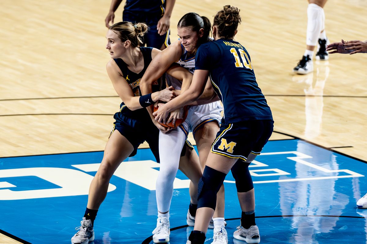 UCLA G Gabriela Jaquez (11) fights for the ball against two defenders during an NCAA basketball game against the Michigan Wolverans, Wednesday January 1st, 2025 in Los Angeles, California. 