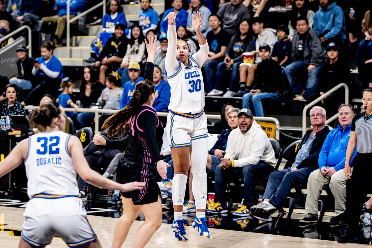 UCLA F Timea Gardiner (30) shoots a three over the defender in a game against Penn State, Wednesday January 15, 2025 in Long Beach, Calif.