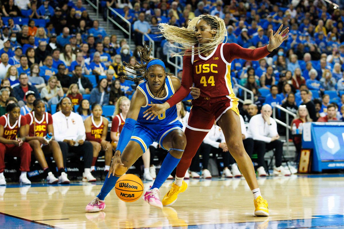 Janiah Barker #0 of the UCLA Bruins dribbles against Kiki Iriafen #44 of the USC Trojans during the first half at Pauley Pavilion on March 1, 2025 in Los Angeles, California. 
