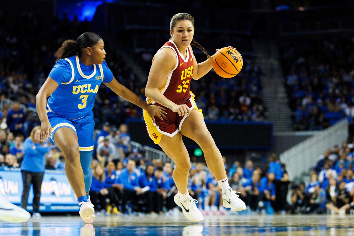 Talia von Oelhoffen #55 of the USC Trojans dribbles against Londynn Jones #3 of the UCLA Bruins during the second half at Pauley Pavilion on March 1, 2025 in Los Angeles, California.