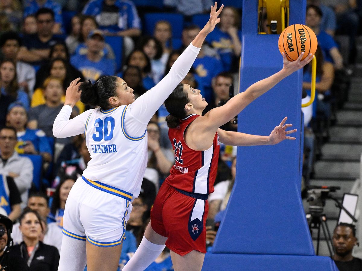 Mar 23, 2025; Los Angeles, California, USA; Richmond Spiders guard Rachel Ullstrom (22) puts up a shot past UCLA Bruins forward Timea Gardiner (30) during the second quarter of an NCAA Tournament second round game at Pauley Pavilion presented by Wescom.