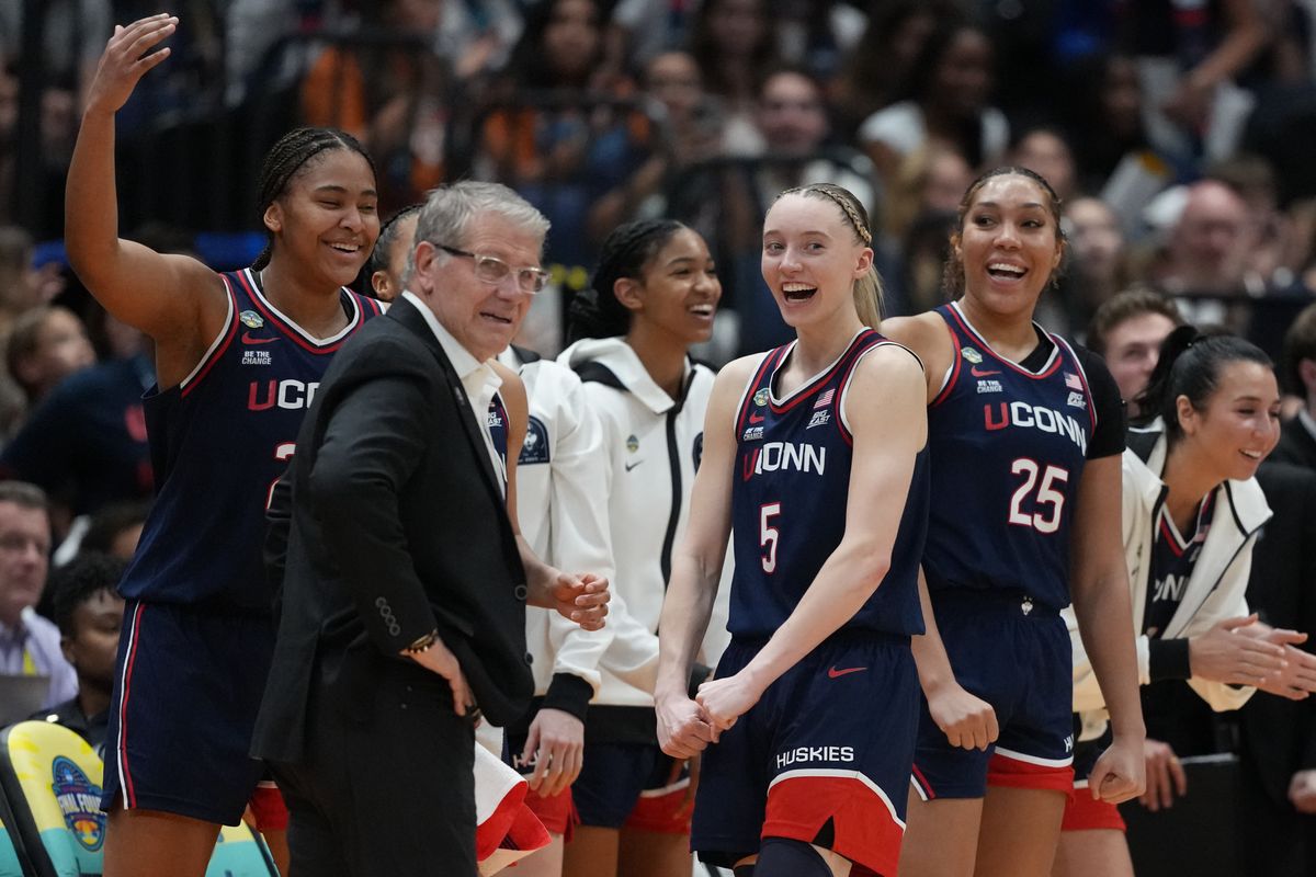 Apr 4, 2025; Tampa, FL, USA; Connecticut Huskies guard Paige Bueckers (5) reacts with head coach Geno Auriemma on the bench during the fourth quarter in a semifinal of the women's 2025 NCAA tournament against the UCLA Bruins at Amalie Arena. Apr 4, 2025; Tampa, FL, USA; Connecticut Huskies guard Paige Bueckers (5) reacts with head coach Geno Auriemma on the bench during the fourth quarter in a semifinal of the women's 2025 NCAA tournament against the UCLA Bruins at Amalie Arena.