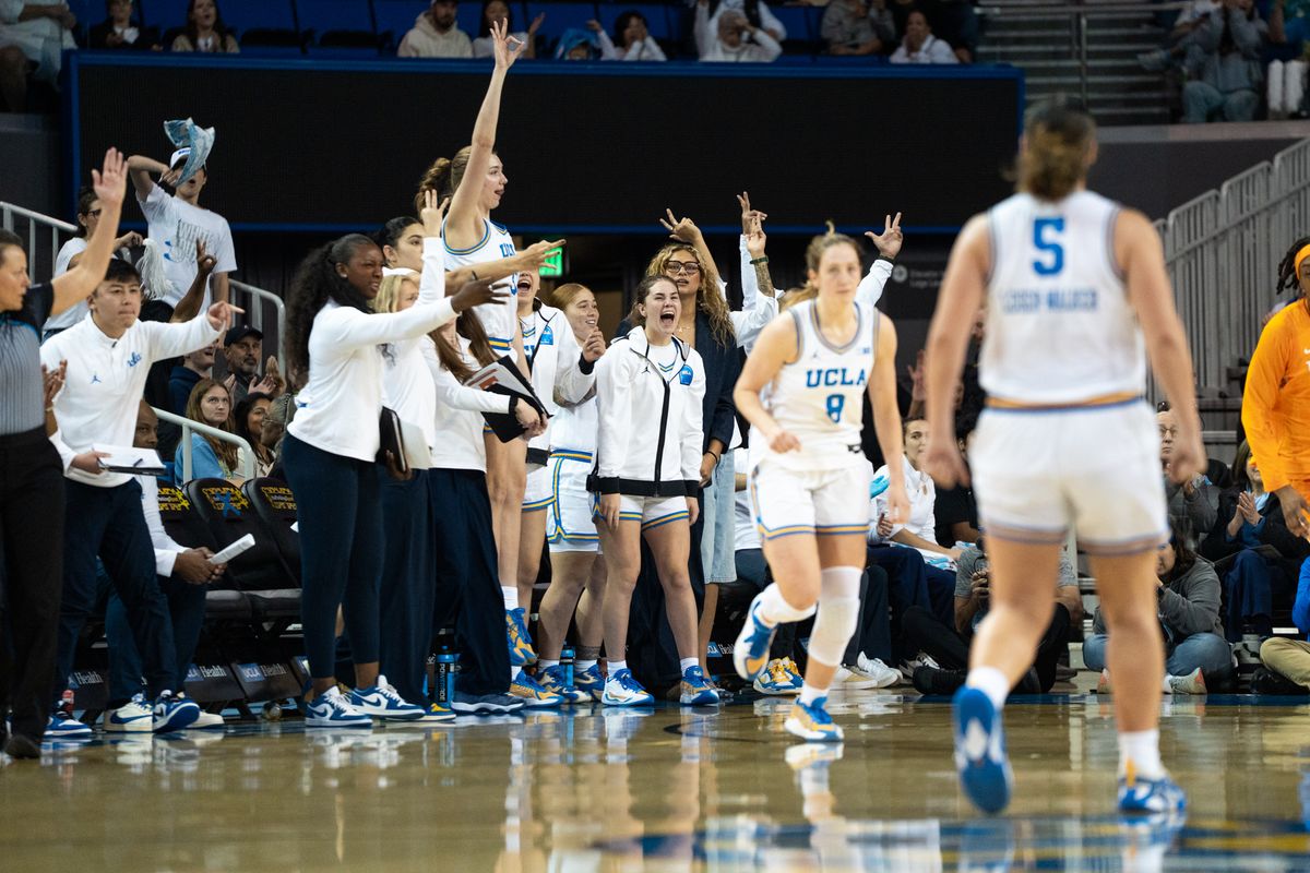 UCLA Bruins bench celebrates after Gianna Kneepkens (8) hits a corner three during an NCAA basketball game against the Tennessee Lady Volunteers on Sunday, November 30, 2025 at Pauley Pavilion in Los Angeles, Calif.