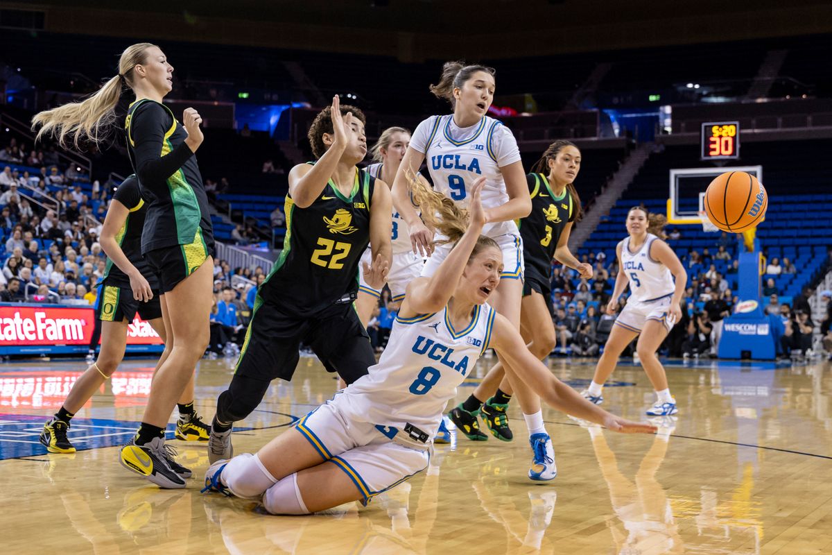 Guard Gianna Kneepkens #8 of the UCLA Bruins dives for the ball during an NCAA basketball game against the Oregon Ducks, Sunday December 7, 2025 in Los Angeles, Calif.