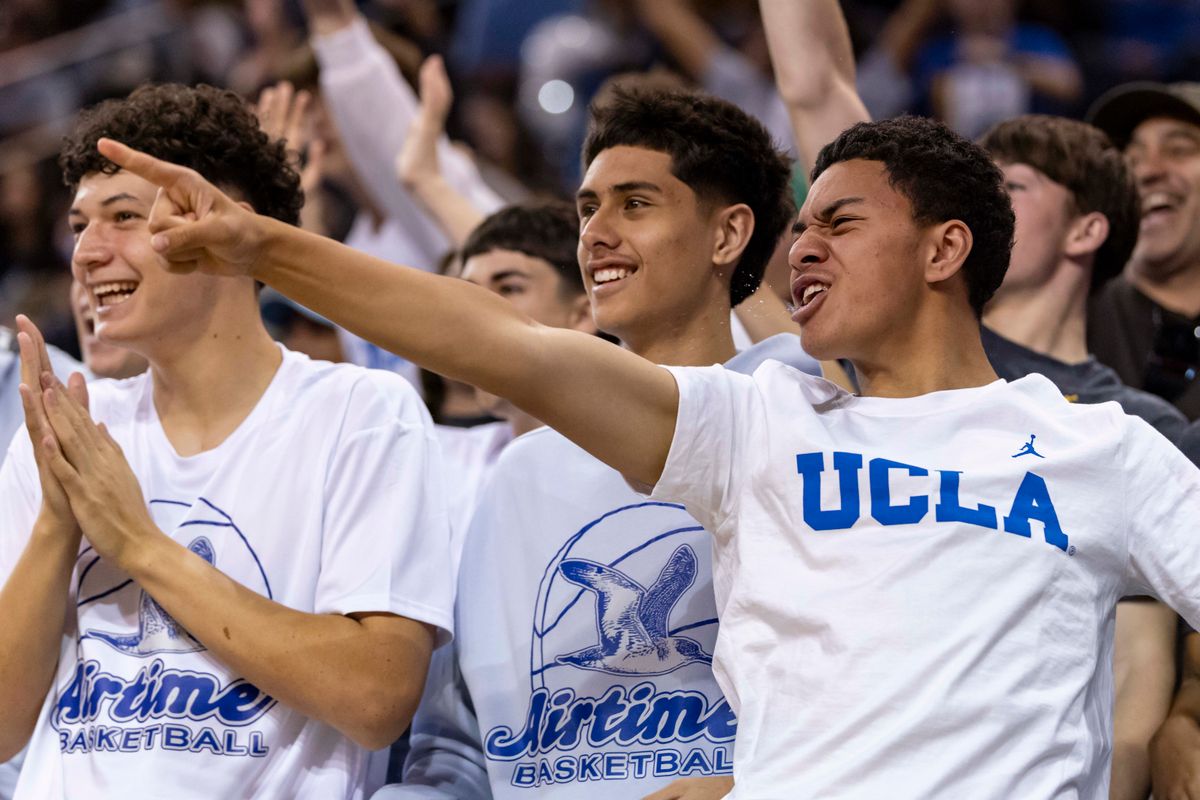 A UCLA fan celebrates in the stands during an NCAA basketball game between the Oregon Ducks and UCLA Bruins, Sunday December 7, 2025 in Los Angeles, Calif.