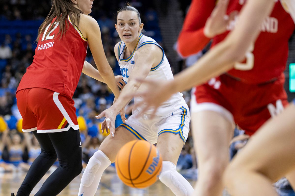 Angela Dugalić #32 of the UCLA Bruins passes through traffic during an NCAA basketball game against the Maryland Terrapins, Sunday January 18, 2026 in Los Angeles, Calif.