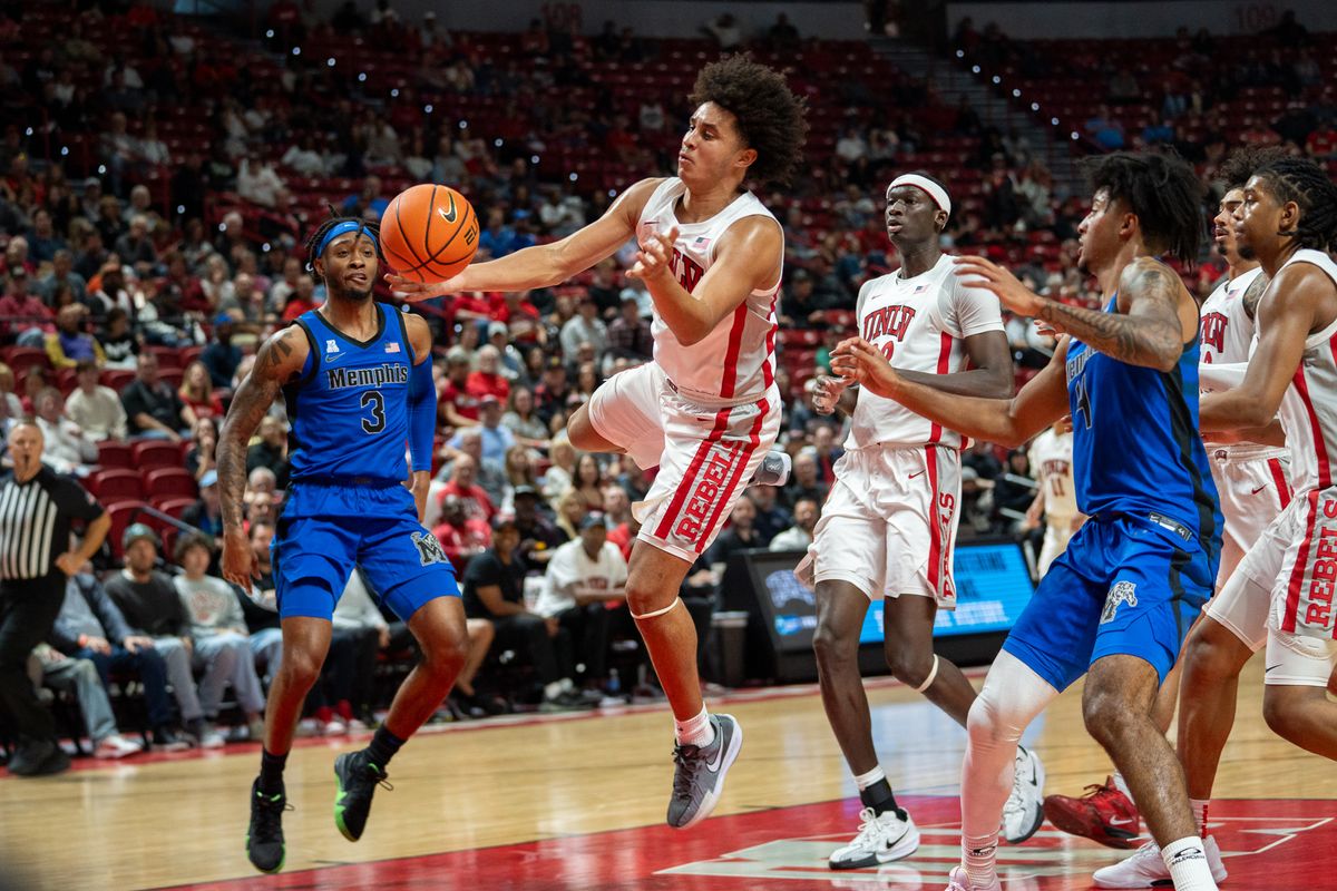 UNLV Jalen Hill (1) reaches for the ball attempting to maintain control during college basketball game against Memphis on Saturday November 9, 2024 in Las Vegas.
