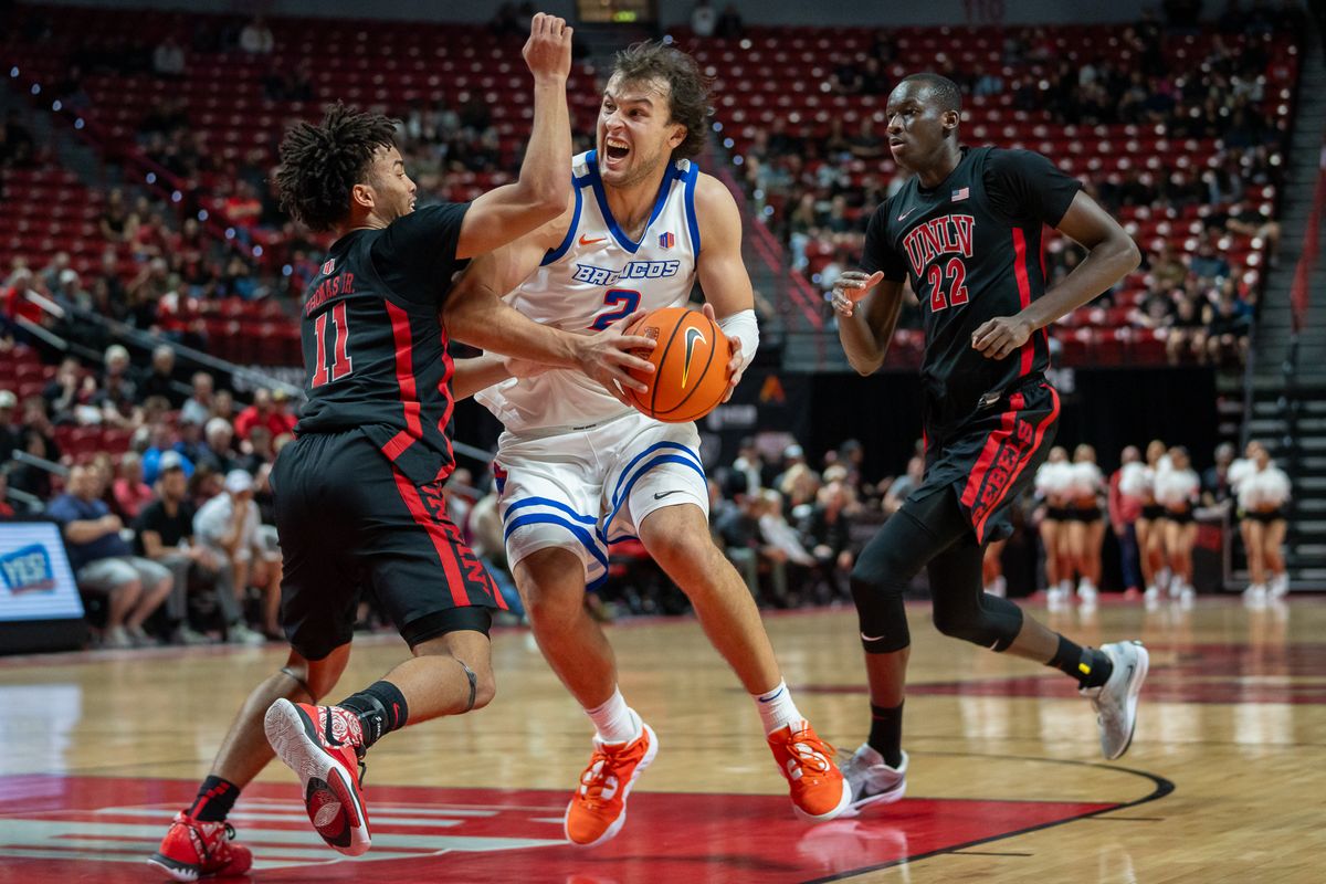 Boise State guard Tyson Degenhart (2) maintains possession of the ball while guarded by UNLV’s Dedan Thomas Jr. (11) drives towards the basket during college basketball game against UNLV on Tuesday February 4, 2025 in Las Vegas. 