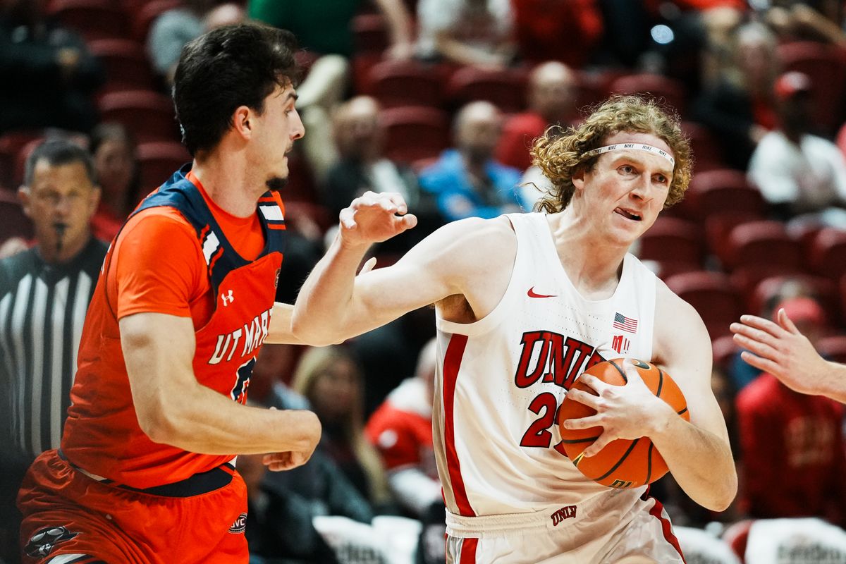 UNLV forward Walter Brown (22) drives towards the basket while guarded by UT Martin James Baas (3) during first half of college basketball game against Tennessee-Martin on Tuesday ,Nov. 4, 2025 at Thomas and Mack Center in Las Vegas.