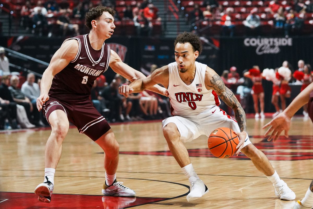 UNLV guard Dravyn Gibbs-Lawhorn (0) drives into the paint while guarded by Montana guard Tyler Issak (8) during first half of college basketball game against Montana on Tuesday, Nov. 11, 2025 at Thomas and Mack Center in Las Vegas. UNLV guard Dravyn Gibbs-Lawhorn (0) drives into the paint while guarded by Montana guard Tyler Issak (8) during first half of college basketball game against Montana on Tuesday, Nov. 11, 2025 at Thomas and Mack Center in Las Vegas.