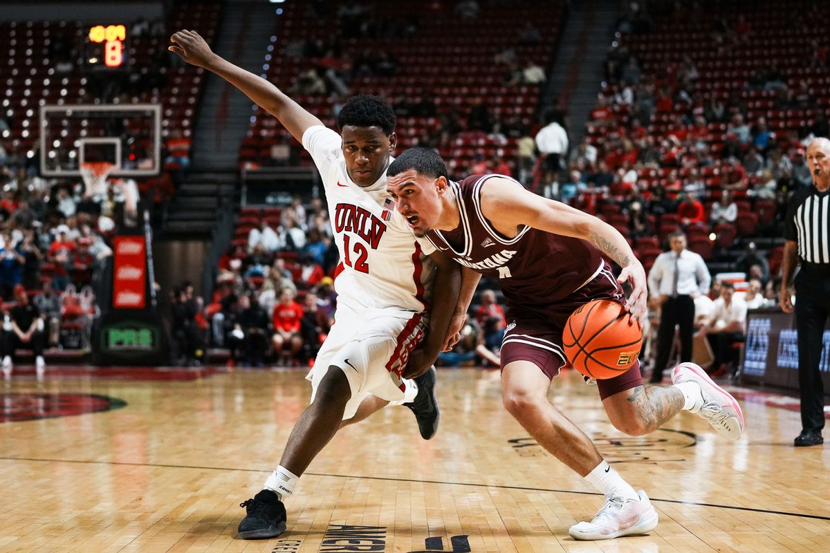 Montana guard Tyler Thompson (4) drives towards the basket while guarded by UNLV guard Issac Williamson (12) during second half of college basketball game against UNLV on Tuesday Nov. 11, 2025 at Thomas and Mack Center in Las Vegas. Montana guard Tyler Thompson (4) drives towards the basket while guarded by UNLV guard Issac Williamson (12) during second half of college basketball game against UNLV on Tuesday Nov. 11, 2025 at Thomas and Mack Center in Las Vegas.