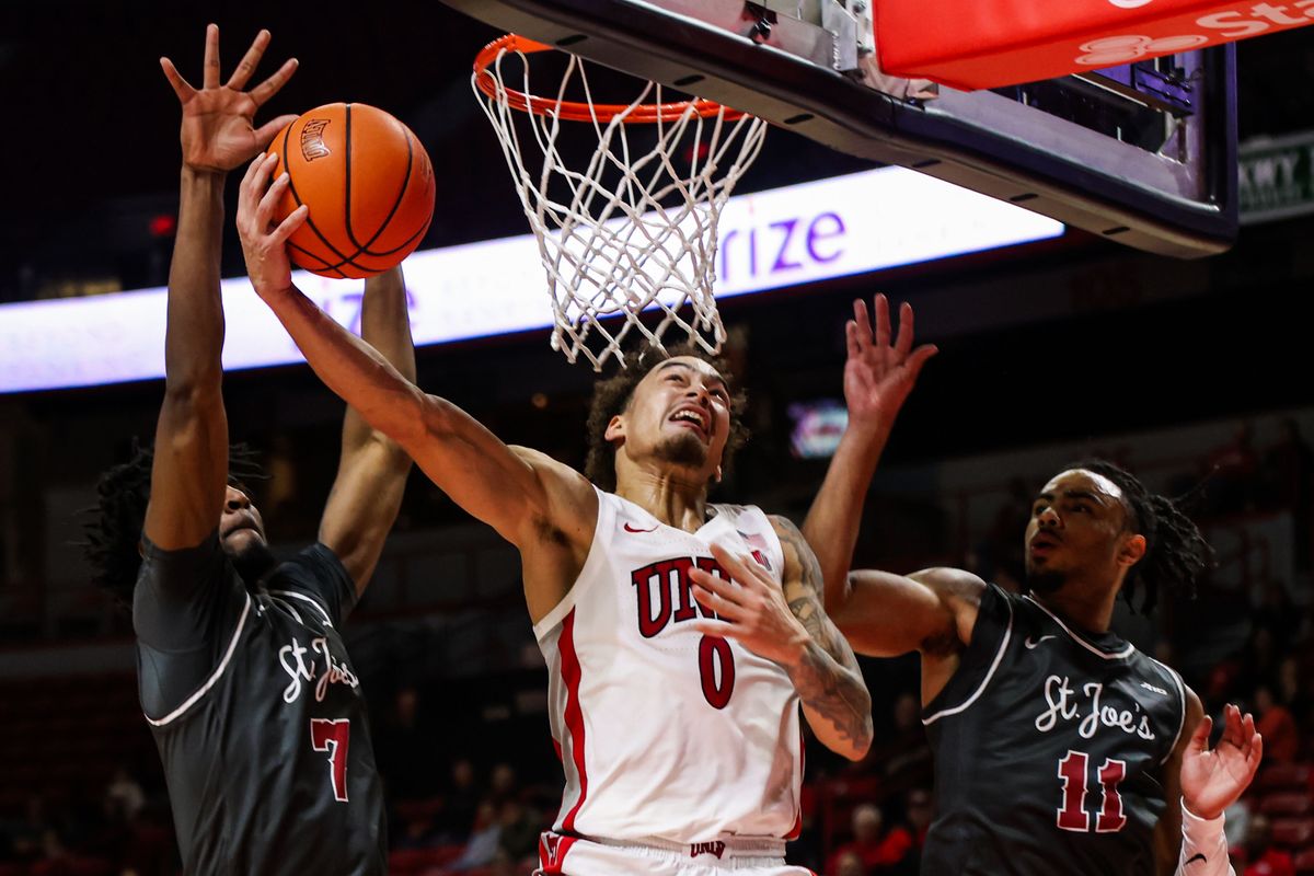  UNLV Runnin' Rebels G Dravyn Gibbs-Lawhorn (0) attempts a layup shot past two Saint Joseph's Hawks players during an NCAA basketball game against the Saint Joseph's Hawks on Thursday November 20, 2025, in Las Vegas, Nevada. 