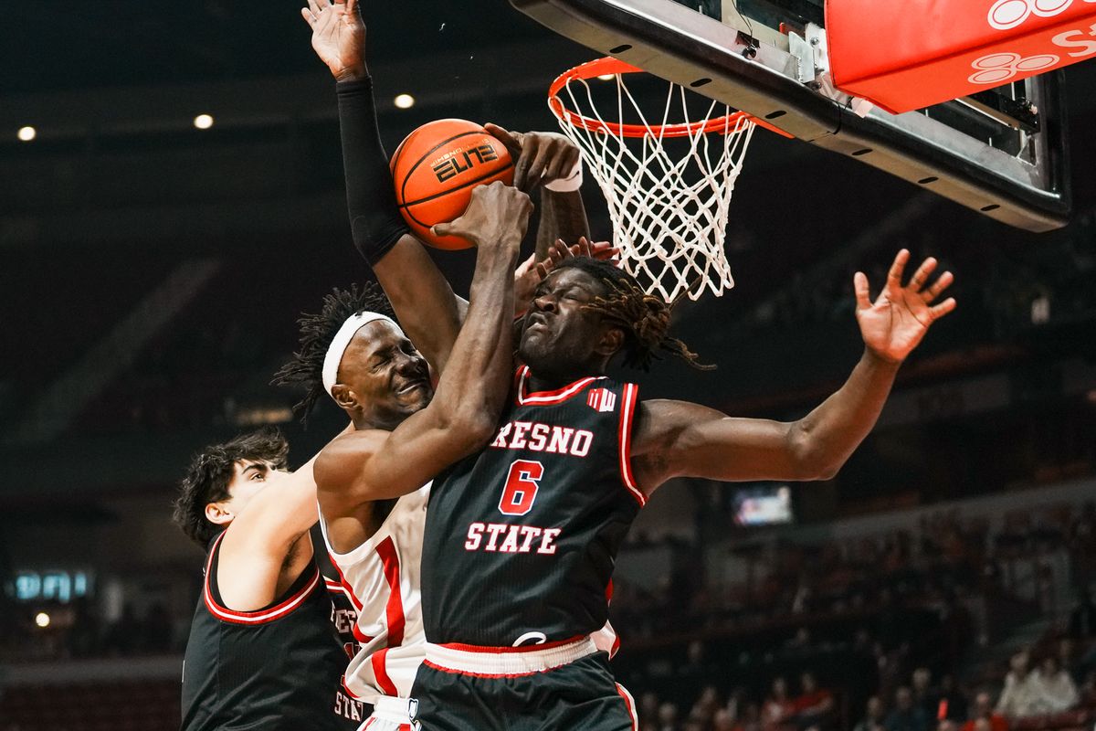 Fresno guard DJ Stickman (6), center Wilson Jacques (16) and UNLV center Emmannuel Stephen (34) reach to rebound the ball during first half of college basketball game against UNLV on Sat., Dec. 20, 2025, at Thomas & Mack Center in Las Vegas.