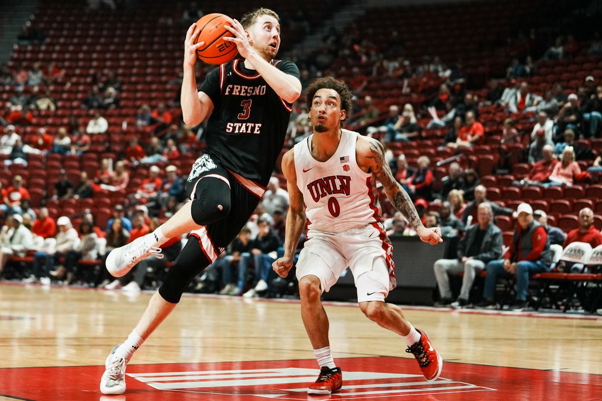 Fresno guard Jake Heidbreder (3) launches towards the basket over UNLV Dravyn Gibbs-Lawhorn (0) during first half of college basketball game against UNLV on Sat., Dec. 20, 2025, at Thomas & Mack Center in Las Vegas.