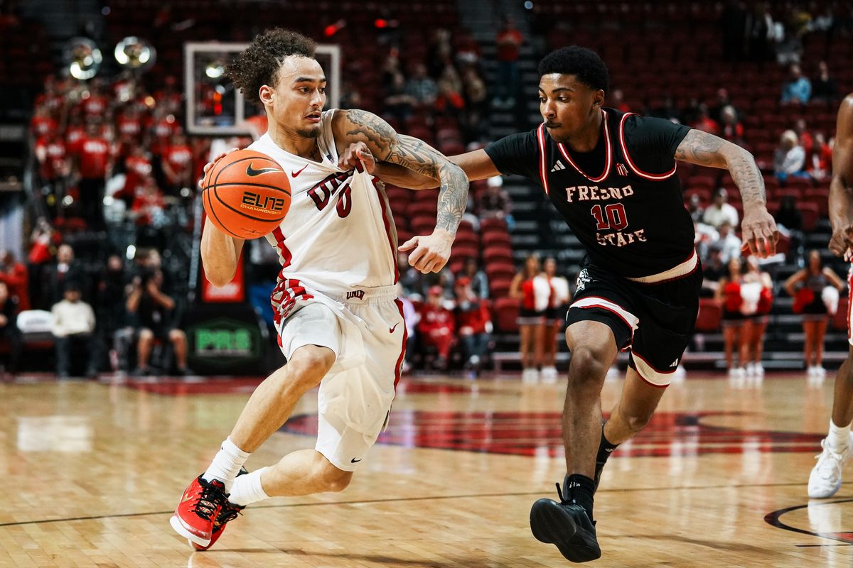 UNLV guard Dravyn Gibbs-Lawhorn (0) drives towards the basket while guarded by Fresno Zaon Collins (10) during second half of college basketball game against Fresno State on Sat., Dec. 20, 2025, at Thomas & Mack Center in Las Vegas.