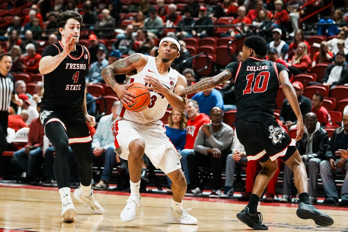 UNLV guard Howie Fleming Jr. (3) takes the ball past Fresno Cameron Fass (4) and Zaon Collins (10) during second half of college basketball game against Fresno State on Sat., Dec. 20, 2025, at Thomas & Mack Center in Las Vegas.