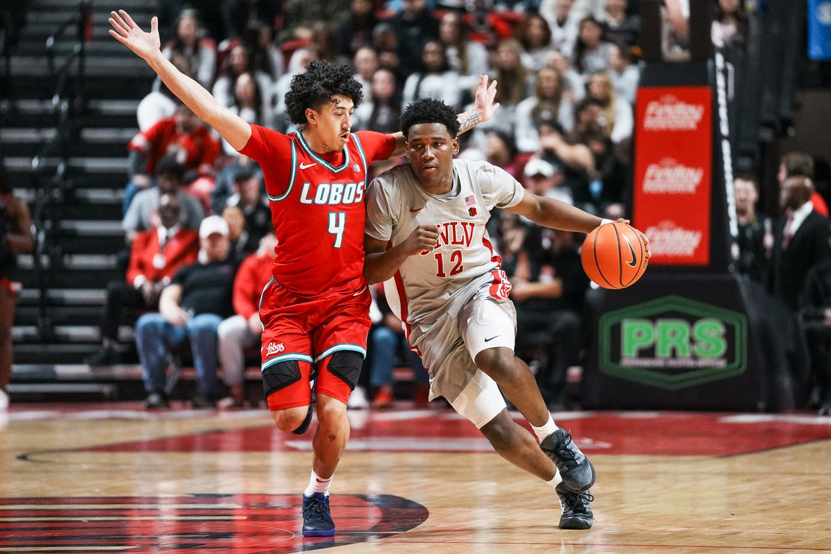 UNLV guard Issac Williamson (12) takes the ball down the court while guarded by New Mexico Uriah Tenette (4) during first half of college basketball game against New Mexico on Tuesday, January 27, 2026 at Thomas & Mack Arena in Las Vegas.