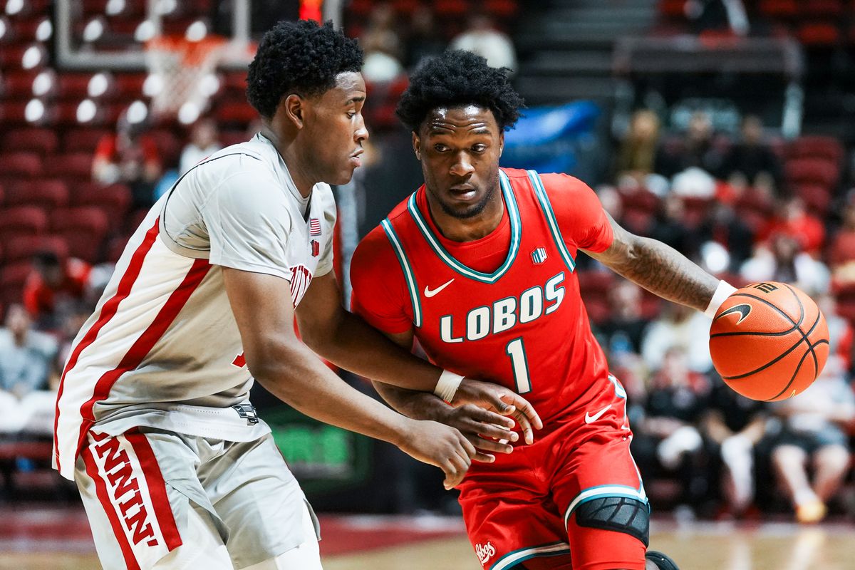 New Mexico guard Deyton Albury (1) drives towards the basket while guarded by UNLV Issac Williamson (12) during second half of college basketball game against UNLV  on Tuesday, January 27, 2026 at Thomas & Mack Arena in Las Vegas.