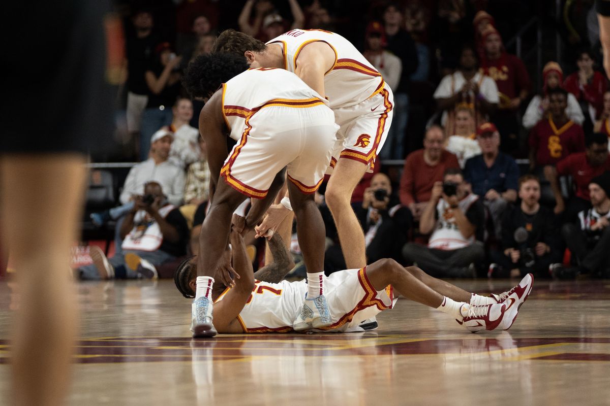 USC Trojans help up Guard Jordan Marsh (7) after he gets hit on a hard screen while defending during a men's college basketball game against the Maryland Terrapins, Tuesday January 13th, 2026 at Galen Center in Los Angeles, Calif.