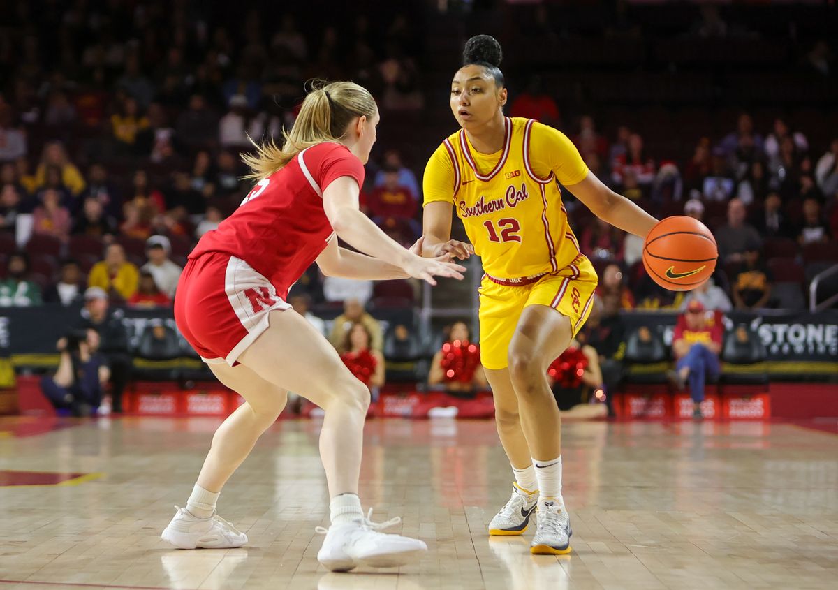 USC G (12) JuJu Watkins attempts to dribble past a Nebraska Cornhusker defender on January 1, 2025 at the Galen Center in Los Angeles, CA.