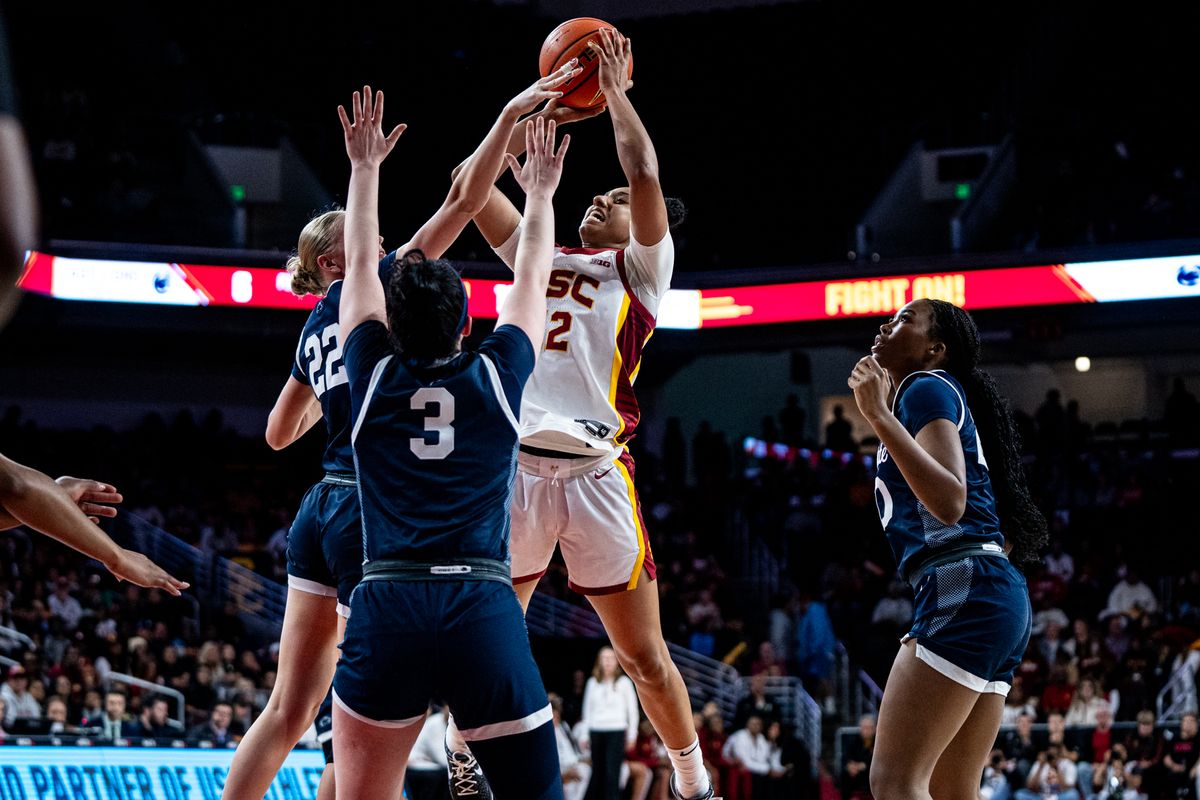 USC G JuJu Watkins (12) takes a jump shot over two defenders in a game against Penn State, Sunday January 12, 2025 in Los Angeles, Calif.