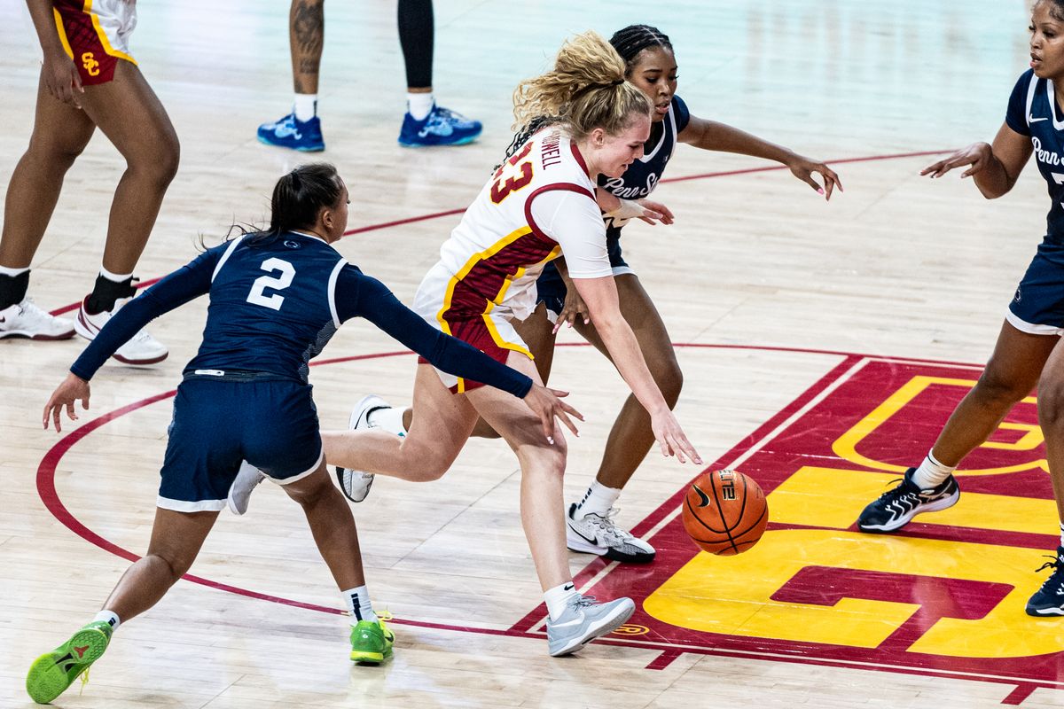 USC G Avery Howell (23) splits two defenders in a game against Penn State, Sunday January 12, 2025 in Los Angeles, Calif.