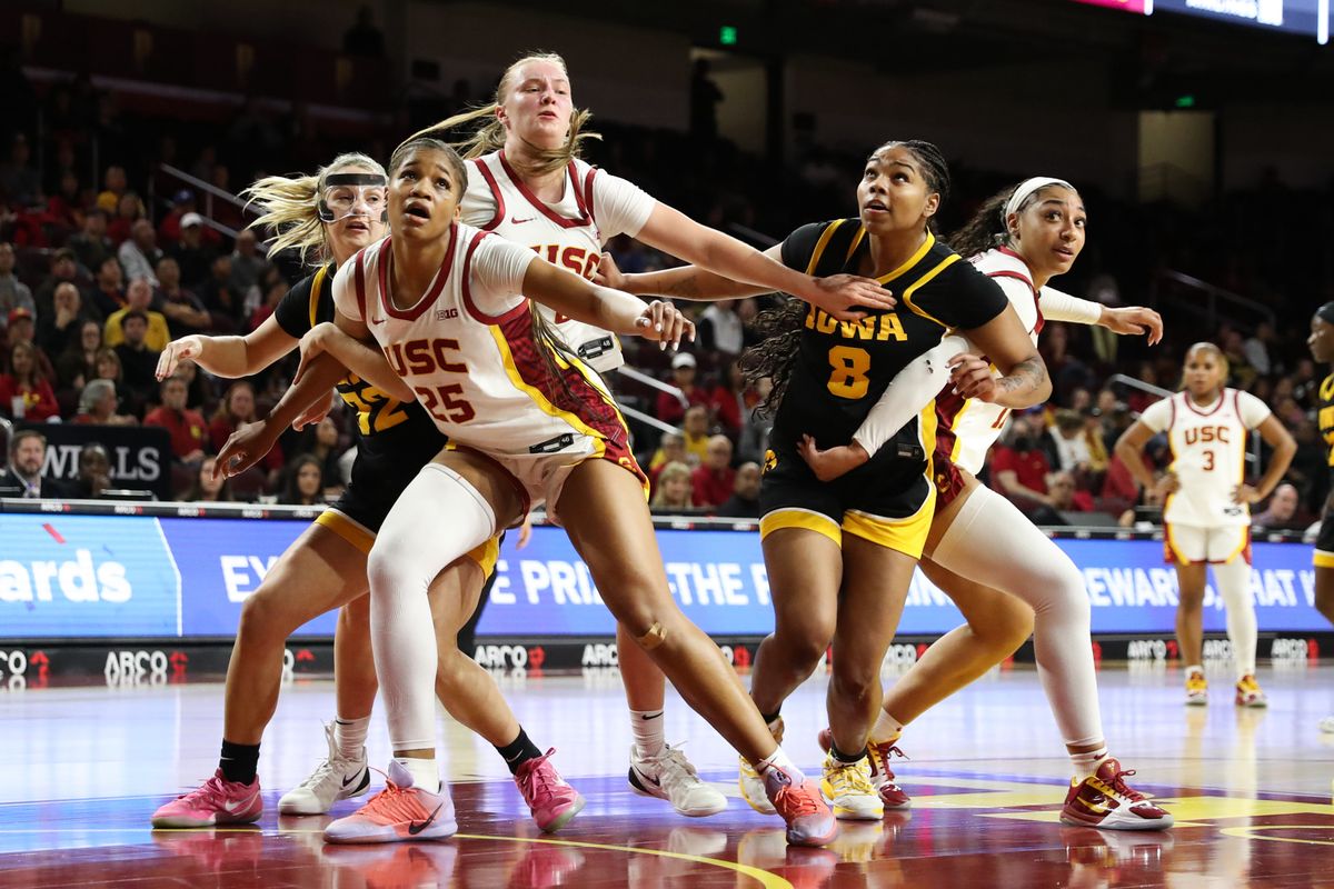 USC Trojan and Iowa Hawkeyes player box out for a rebound during an NCAA basketball game on January 29, 2026 in Los Angeles, CA.