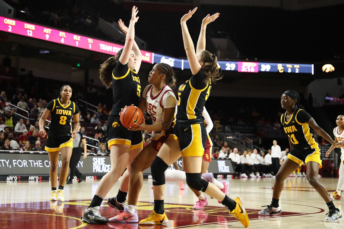 USC guard Kara Dunn (25) drives between two defenders during an NCAA basketball game against the Iowa Hawkeyes on January 29, 2026 in Los Angeles, CA.