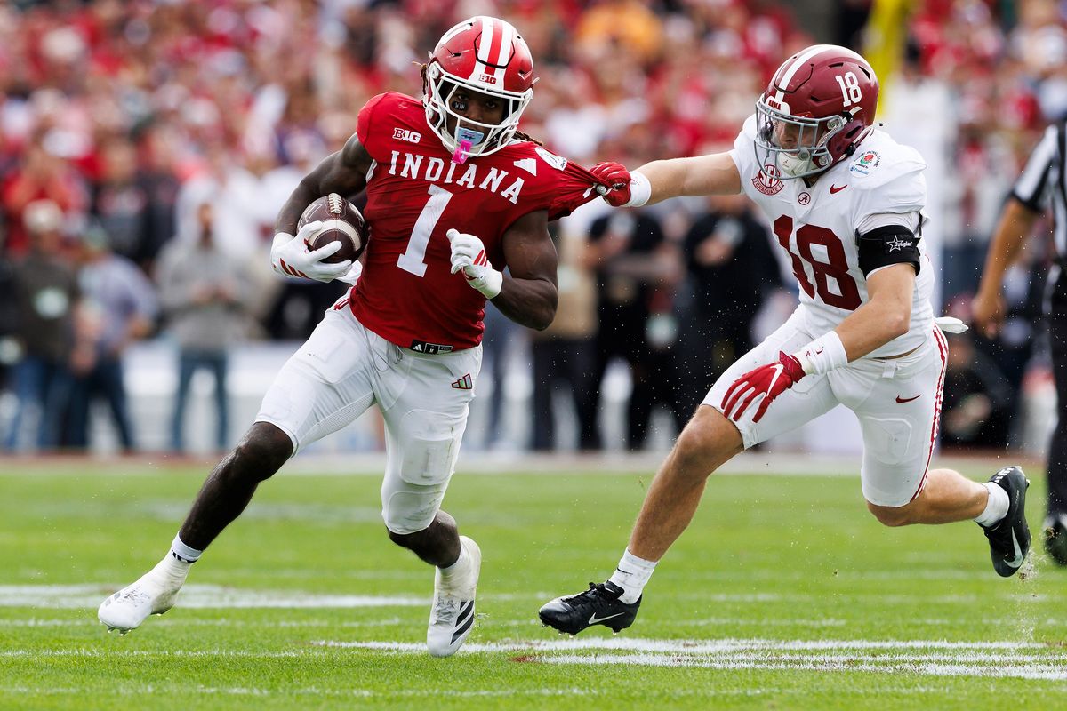 Roman Hemby #1 of the Indiana Hoosiers runs with the ball against Bray Hubbard #18 of the Alabama Crimson Tide during the game at Rose Bowl on January 1, 2026 in Pasadena, California. 
