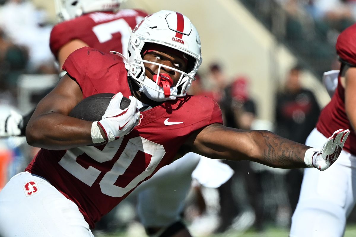 Stanford Cardinal running back Micah Ford, #20, stiff arms a Hawai'i defender while rushing during an NCAA football game against the Hawai'i Rainbow Warriors, Saturday, August 24, 2025, in Honolulu, Hawai'i.