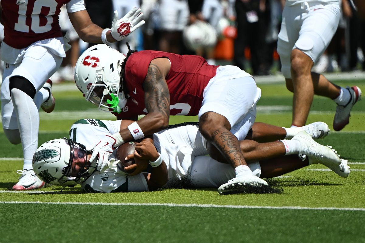 Stanford Cardinal safety Jay Green, #5, tackles University of Hawai'i Rainbow Warriors quarterback Micah Alejado, #12, during an NCAA football game against the Hawai'i Rainbow Warriors, Saturday, August 23, 2025, in Honolulu, Hawai'i.